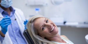 happy woman sitting in dental exam chair