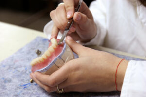 Dentist Fixing Dentures